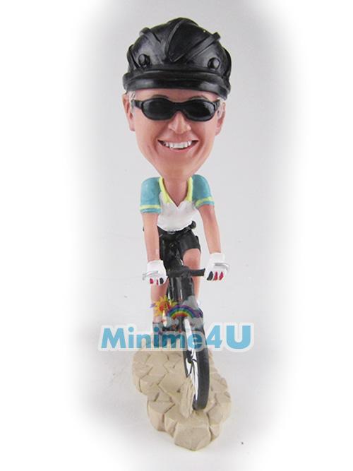 riding bike figurine 